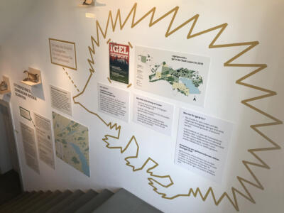 Eine Wand der Ausstellung Stadtwildtiere mit einem riesigen Igel und Informationstafeln